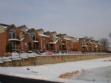 some buildings overlook a pond