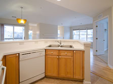 kitchen with breakfast bar is open to living and dining