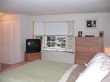 large master bedroom with bay window