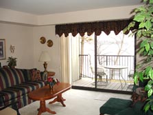 living room with doorwall to deck