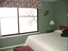 spacious master bedroom with gorgeous lake views